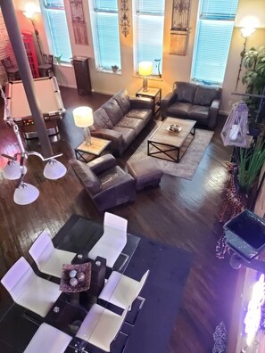 Relax in this inviting living room with a sectional sofa, coffee table, and dining area.