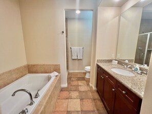A bathroom with a bathtub, a sink, and a toilet.