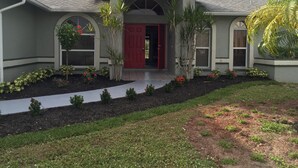 A two-story house with a red door, arched windows, and a covered front porch. - Villa Alegria, Your Home Away From Home! (Cape Coral)