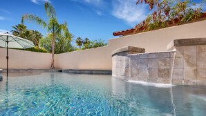 A clear swimming pool with a tiled edge, surrounded by a low wall and palm trees. - Fabulous Location @ Rancho Relaxo  (La Quinta)