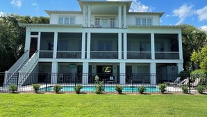 A large, multi-story house with a swimming pool in front. - Beautiful Oceanfront 5 Bedroom Home With Pool  (Isle of Palms)