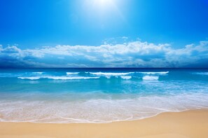 A beach with clear blue water and a sandy shore. - 5 Min Walk - Golf Cart Included - Central Beach - House w Large Backyard & Pool (Vero Beach)