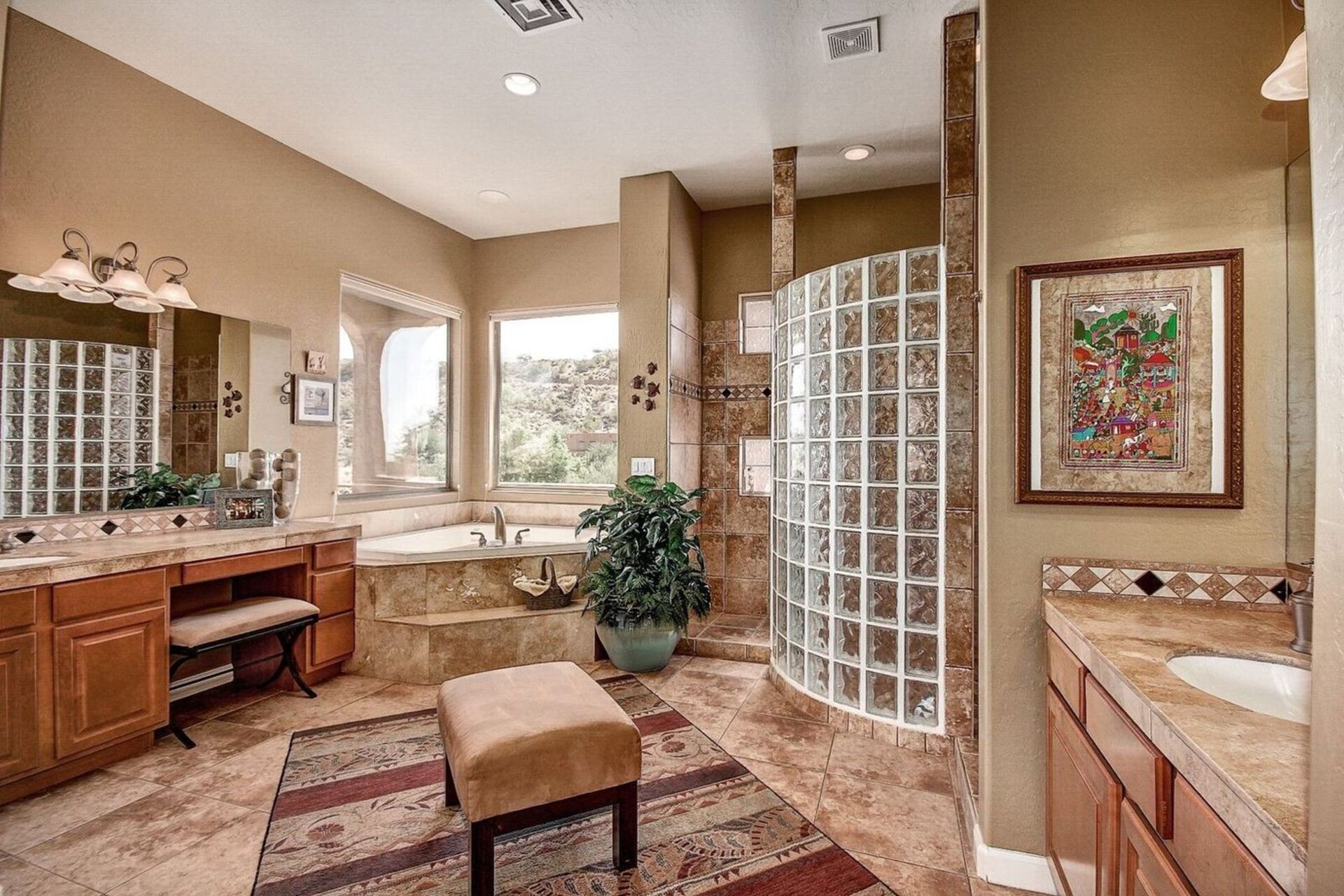 A spacious bathroom with a large bathtub, a double sink vanity, and a shower enclosure.