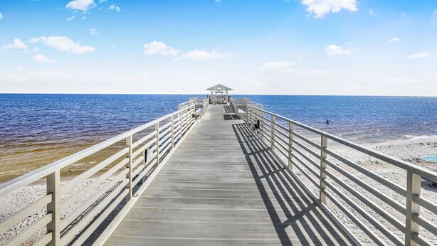 A pier extending into the sea with a gazebo at the end. - Direct Gulf Front View And Your Very Own Private Pier 504W (Orange Beach)