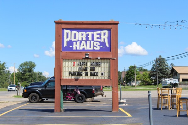 A sign for Porter Haus with a parking sign underneath.