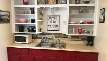 Fridge, microwave, coffee/tea maker, cookware/dishes/utensils