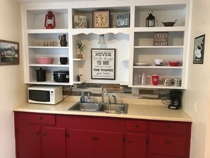 Fridge, microwave, coffee/tea maker, cookware/dishes/utensils