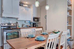 Enjoy cooking in this well-equipped kitchen with a stove, microwave, and oven, and dine at the adjacent table.