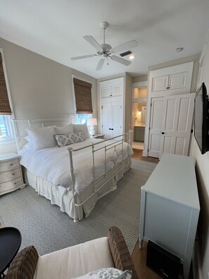 A bedroom with a bed, bedside tables, a desk, a wardrobe, and a ceiling fan. - "Summer Magic" in Carillon Beach - RENOVATED! (Sunnyside)
