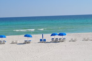 A beach with white sand and blue umbrellas. - "Summer Magic" in Carillon Beach - RENOVATED! (Sunnyside)