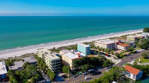 A coastal town with buildings near the beach, a road, and a clear view of the ocean. - Come Relax And Enjoy What The Beach Has To Offer (Indian Rocks Beach)
