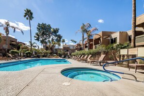 A pool area with lounge chairs and palm trees. - Nicely Updated Comfortable Condo in Old Town Scottsdale  (Scottsdale)