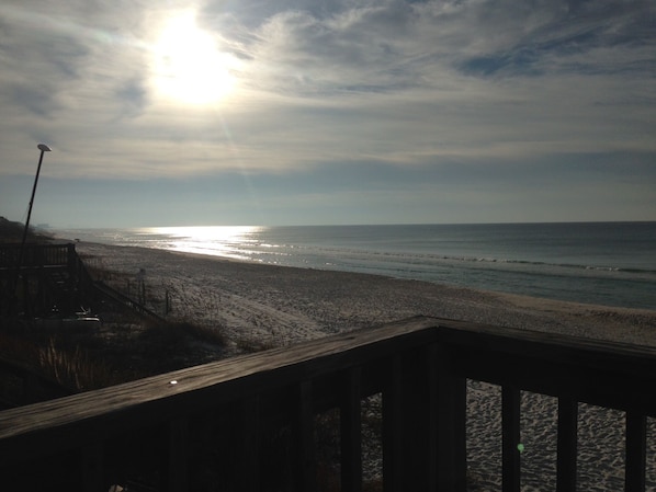 A beach with a wooden deck in the foreground. - Beach Treasure - Seacrest Beach -Best Value On 30A (Panama City Beach)