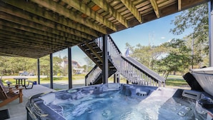 A hot tub under a wooden pergola with a view of a residential area and a staircase. - WolfRun Lake View Chalet, 200 feet from Lake, Hottub (Albrightsville)