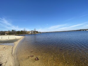 Enjoy a serene lakeside retreat with a clear view of the shoreline and a sandy beach.