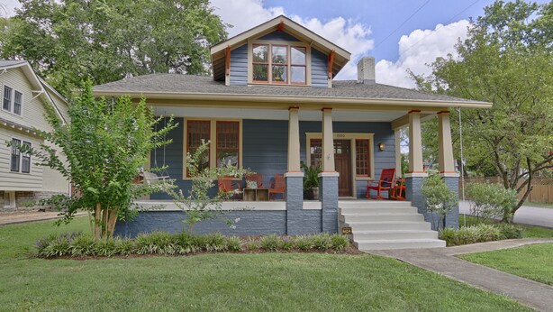 A two-story house with a porch, a chimney, and a small garden. - Classic 12 South Bungalow (Nashville)