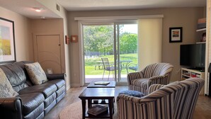 A living room with a sofa, armchairs, a coffee table, and a TV. - Cozy and Convenient! (Cedar)