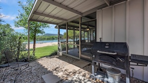 A covered patio with a grill, seating, and a view of a lake and mountains. - Million-dollar View & Affordable Too! Kayaks free for use (Kingsland)