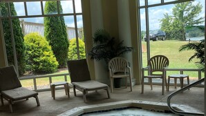 A hot tub area with a view of a backyard. - Romantic SML Penthouse, Bernard’s Landing. Smith Mountain Lake 3 Pools (Moneta)