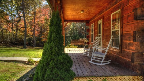 A wooden cabin with a porch, rocking chairs, and a stone pathway leading to the entrance. - Weekend hiking trips at Fall Creek Falls & surrounding State Parks. (Spencer)