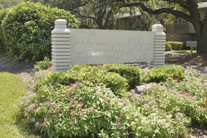 Experience a serene environment surrounded by lush greenery and flowering plants at Fairway Lane.