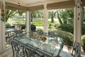 Enjoy a serene view of the lush garden and tranquil lake from the large windows in this elegantly designed room.