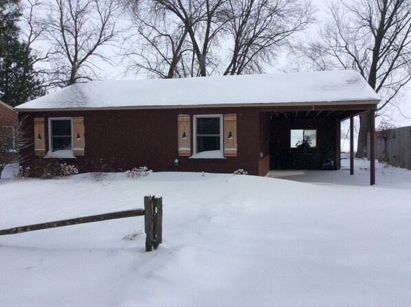A two-story house with a covered porch and a garage.
