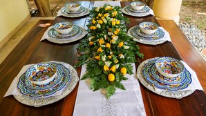 A dining table set with ornate bowls and plates, surrounded by a decorative floral arrangement. - French-Colonial Villa,Close to Paseo Montejo, Hotels and Restaurants! (Mérida)