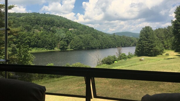 A view from inside a room with a window overlooking a lake surrounded by forested hills. - Private RV Camping on the Connecticut River with local mountain views!! (Monroe)