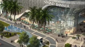A modern building with a curved glass facade and the text "KINGKEY BANNER" on the side. - Tata Hotel Apartment Shenzhen (Shenzhen)