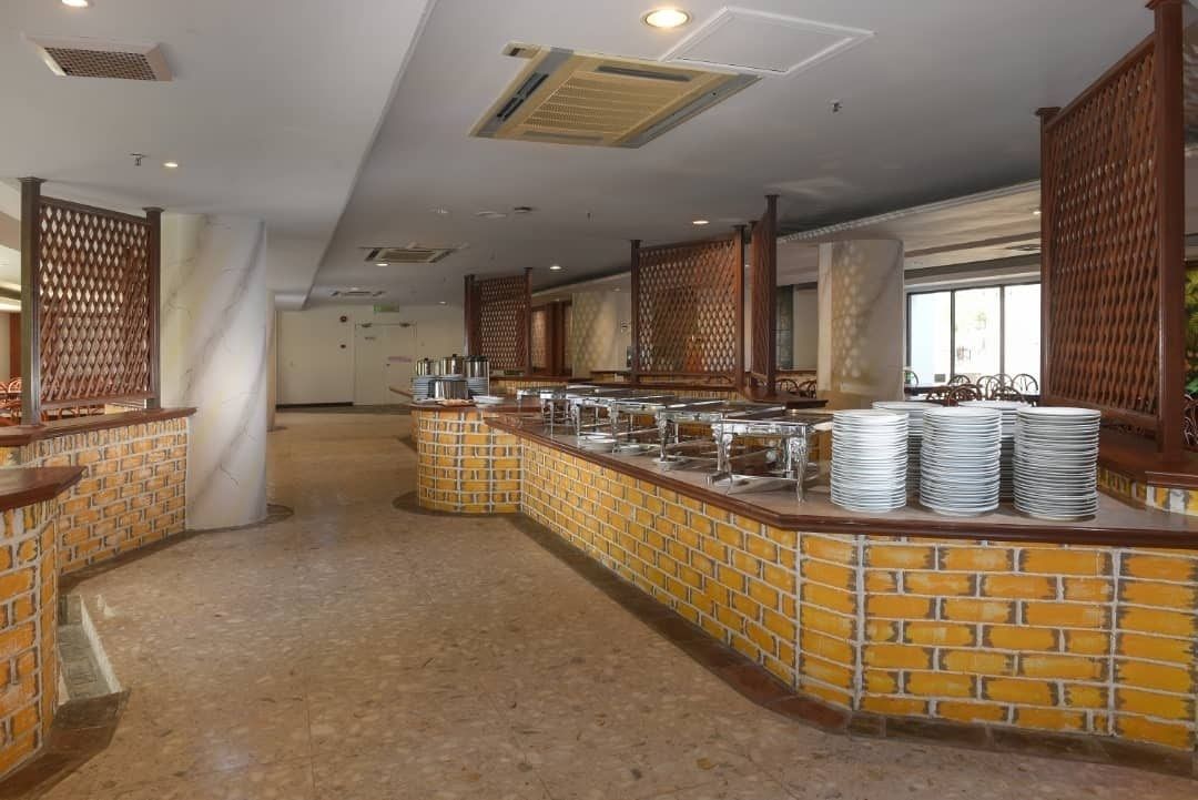 A buffet area with a brick counter and multiple serving stations.