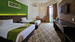 A hotel room with two beds, a desk, a chair, a TV, and a balcony with curtains. - De Greenish Village Langkawi (Langkawi)