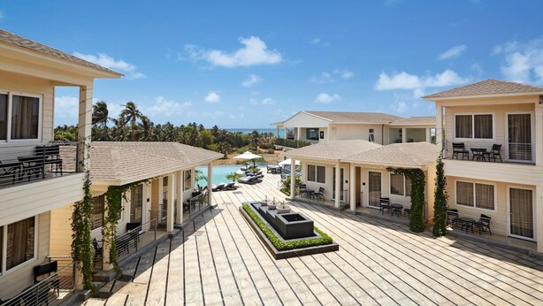 A resort with multiple guest rooms, a pool area, and a view of the ocean. - Acacia Resort & Spa Morjim Goa (Morjim)