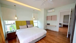 A bedroom with a bed, bedside tables, a ceiling fan, and a window.