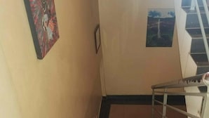 A staircase with a marble floor leading to a landing. - Hotel Hensek (Kampala)