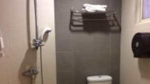 A small bathroom with a toilet, a sink, and a shower. - Kim Tian Hotel Star (Singapore)