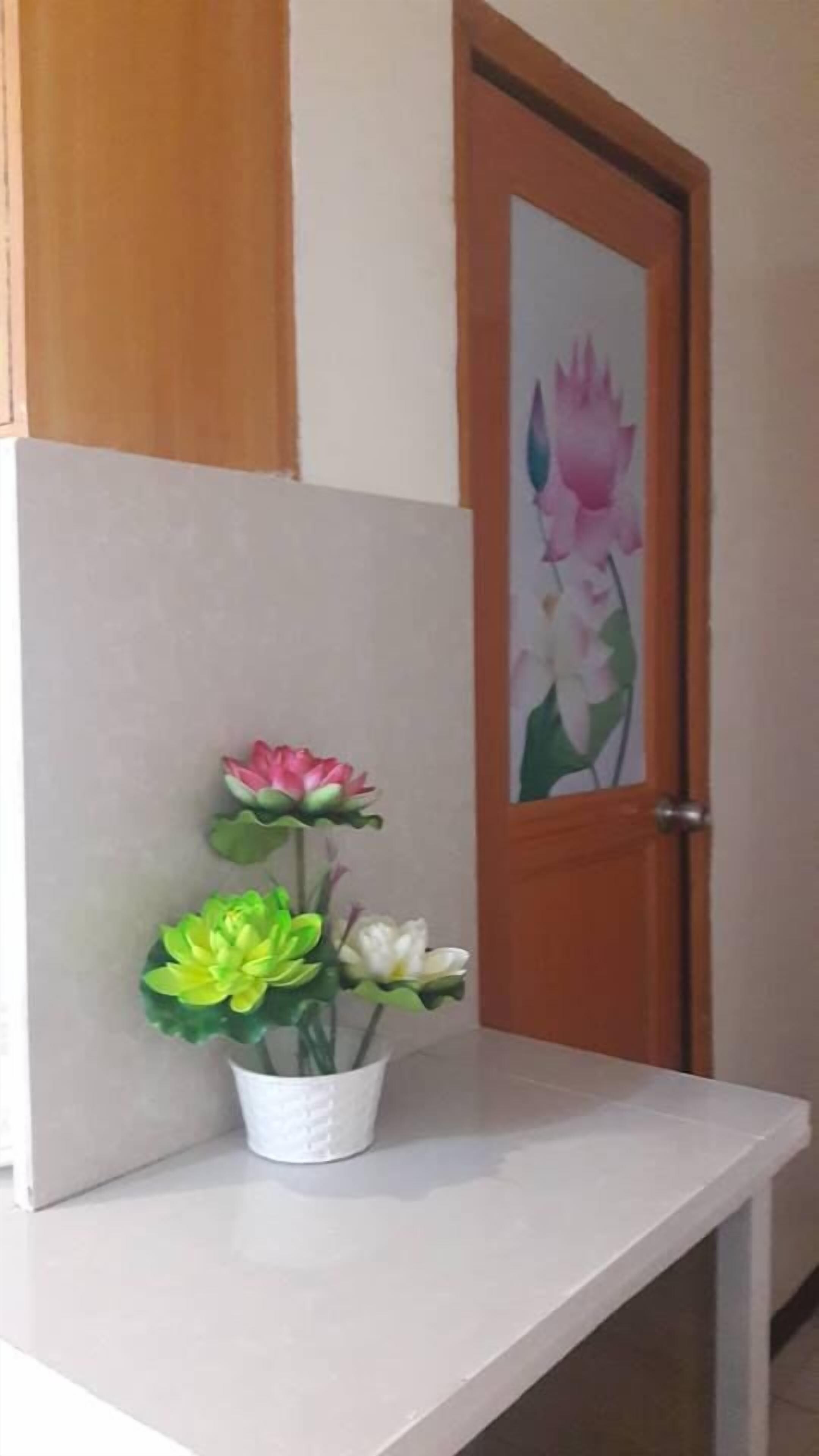 A small white table with a potted plant.