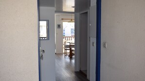 A hallway leading to a dining area with a view of the outside. - Nice T2 view on the port of Crouesty (Arzon)