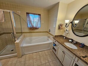 Bathtub, hair dryer, towels, toilet paper
