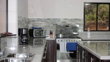 Een koelkast, een oven, een kookplaat, een koffiezetapparaat/waterkoker