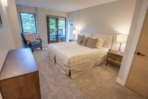 A bedroom with a bed, a chair, a desk, and a door. - Pinnacle Ridge 36 - Ski in Ski out, Private Hot Tub, Wood Fireplace (Whistler)