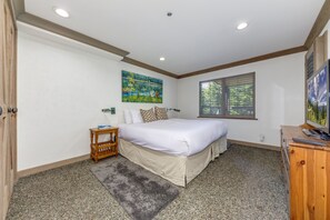 A bedroom with a bed, a painting, a window, and a desk. - Pinnacle Ridge 5 - Ski in Ski out, Private Hot Tub, Gas Fireplace (Whistler)
