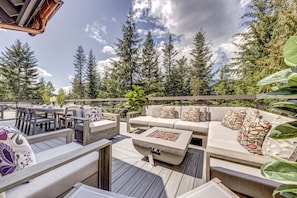 An outdoor deck with a sofa, chairs, and a fire pit. - Pinnacle Ridge 5 - Ski in Ski out, Private Hot Tub, Gas Fireplace (Whistler)