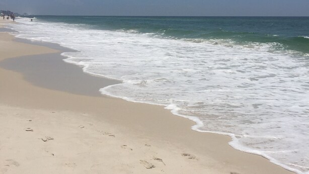 A beach with footprints in the sand and waves crashing onto the shore. - Fall is coming! Book! Unit #1309 @ Seaside Beach & Racquet Club ~Prime~Location~ (Orange Beach)