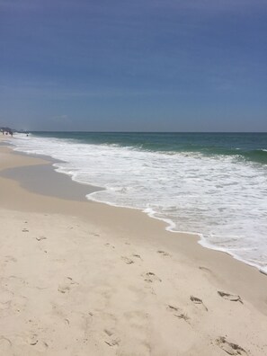 A beach with footprints in the sand and waves crashing onto the shore. - Fall is coming! Book! Unit #1309 @ Seaside Beach & Racquet Club ~Prime~Location~ (Orange Beach)