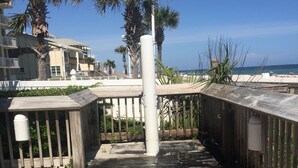 A wooden deck with a metal railing, palm trees, and a view of the ocean. - Fall is coming! Book! Unit #1309 @ Seaside Beach & Racquet Club ~Prime~Location~ (Orange Beach)