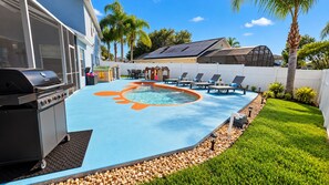 A backyard with a swimming pool, a barbecue grill, and a fenced area with lounge chairs. - 10 minutes to Disney! Two Pools & Spa! No Carpet! Themed Rooms @The Nemo House (Kissimmee)