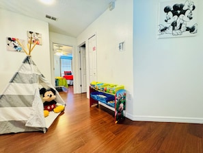 A child's play area with a teepee, Mickey Mouse plush toy, and storage bins with cartoon characters. - 10 minutes to Disney! Two Pools & Spa! No Carpet! Themed Rooms @The Nemo House (Kissimmee)
