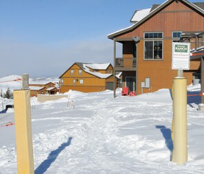 A snow-covered area with a building labeled "Ranby Ranch Colorado" and a sign indicating "Area Boundary." - Beautiful 5 bedroom + sleeping loft ski-in/ski-out Mountain House (Granby)