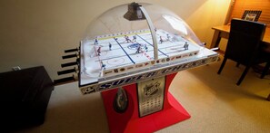 A tabletop hockey game with a transparent dome and NHL logo. - Snowy Creek 4 - Ski in Ski out, Private Hot Tub, Short Walk to Whistler Village (Whistler)